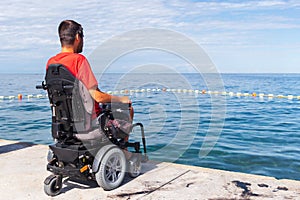 Man sitting in a wheelchair on the beach