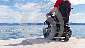 Man sitting in a wheelchair on the beach