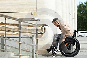 Man sitting in wheelchair using ramp