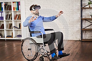 Man sitting in a wheelchair and using a VR headset