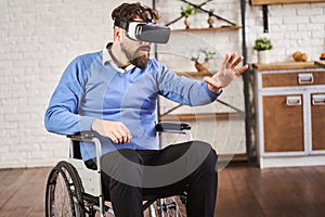 Man sitting in a wheelchair and wearing a VR headset