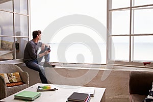 Man Sitting At Window And Looking At Beautiful Beach View