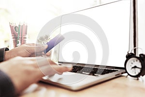 Man sitting wood table and using notebook with credit card for online payment, Man`s hands holding a credit card and using laptop