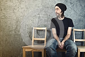 Man sitting on wooden chair and waiting