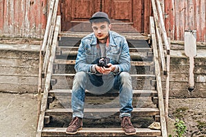 Man sitting on a wooden staircase. Old house