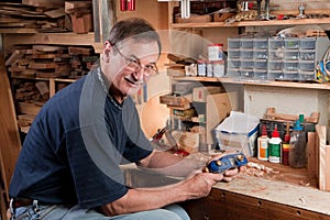 Man sitting at workbench in workshop