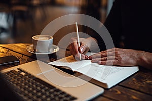 Man sketching design for new web into diary