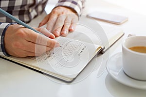 Man sketching graphic sketch in office, close up