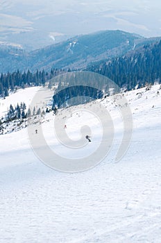 Man ski free ride downhill at winter season in shadow on beautiful sunny day