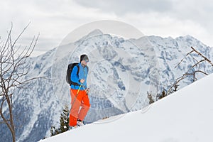 Man with ski mountaineering climb towards the summit