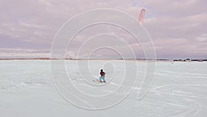 Man ski on snow kite holds an action camera and takes a picture of Selfie.