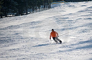 Man skier skiing downhill at ski resort