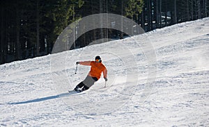 Man skier skiing downhill at ski resort