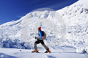 Man skiing on fresh powder snow.