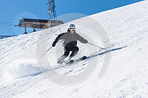 A man with skis stands high in the mountains enjoying the scenery. Go downhill skiing, extreme relaxation