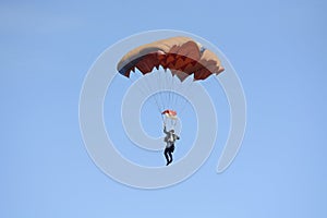 Man skydiver parachuting down to the ground