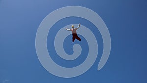 Man in a Skydiving Suit Flies in the Air Above a Vertical Wind Tunnel.