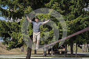 Man slacklining at the sunny day