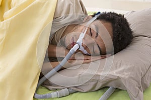 Man with sleep apnea using a CPAP machine