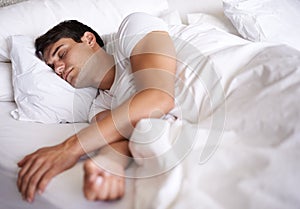 Man, sleep and bed for peace, wellness and home for rest in pajamas and bedroom for relaxing and sleepwear. Male person