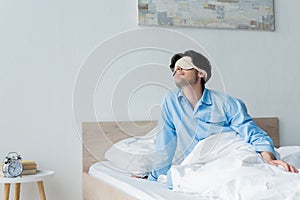 man in sleep mask sitting on