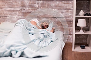 Man sleeping alone in his comfortable bed