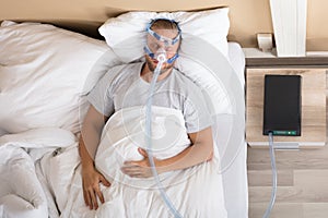 Man With Sleeping Apnea And CPAP Machine