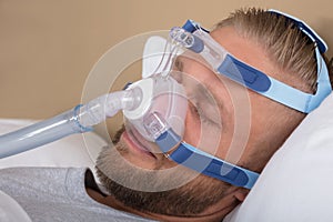 Man With Sleeping Apnea And CPAP Machine photo