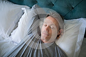 Man sleeping on bed in bedroom