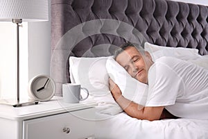 Man sleeping on comfortable pillow in bed