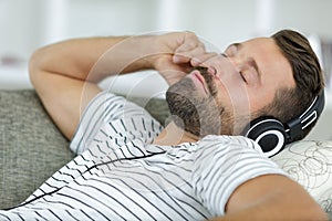 man sleeping on couch at home