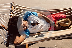 Man sleeping in a hammock on the beach