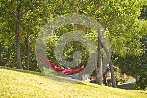 Man sleeping in a red hammock