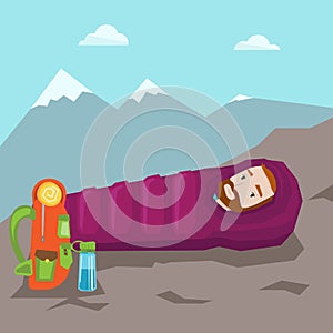 Man sleeping in sleeping bag in the mountains.