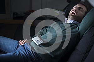 Man sleeping and snoring in front of television
