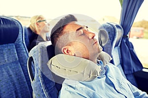 Man sleeping in travel bus with cervical pillow