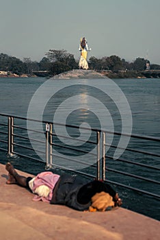 Man sleeping under Lord Shiva`s feet