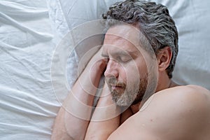 Man sleeping in white bed. Sexy shirtless man sleeping in bed at bedroom. Hispanic mature man sleeping at home at