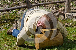 Man sleeping on a wooden bench