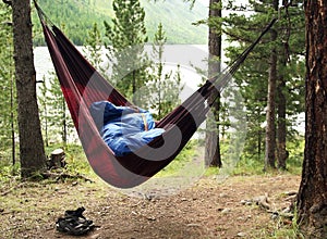 Man sleeps in a hammock and in a sleeping
