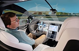 A man sleeps while his car is driven by an autopilot.