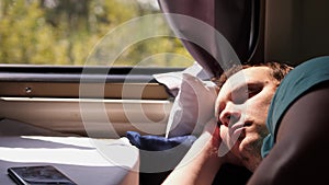 Man sleeps in train tired long journey by rail