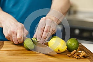 Man slicing limes and lemons