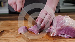Man slicing pork meat on a table, conceptual idea. Healthy, preparing.