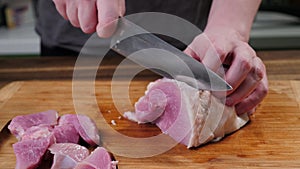 Man slicing pork meat on a table, conceptual idea. Lamb, healthy.