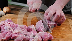 Man slicing pork meat on a table, working process closeup. Healthy, food.
