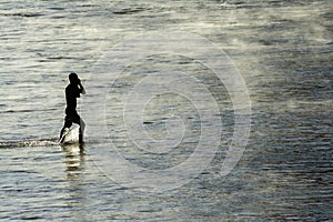 Man slowly coming out of the sea from the beach of Ondina after bathing