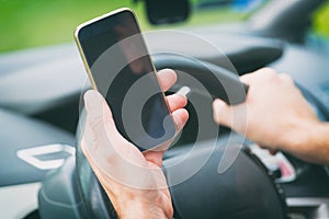 Man with smart phone in the car