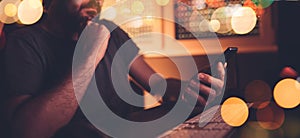 Man with smart phone in home office interior