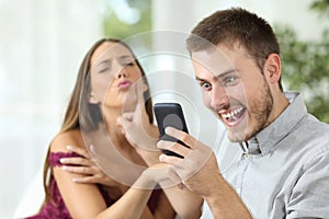 Man with a smart phone ignoring a sex proposal photo